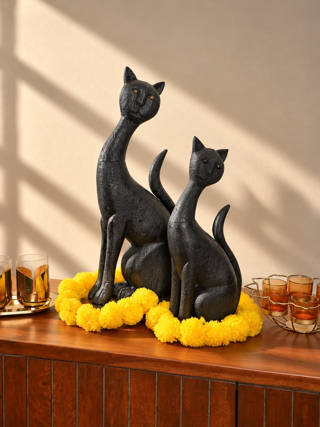 Mela Long-Neck Cat Sculpture styled with marigolds for Diwali