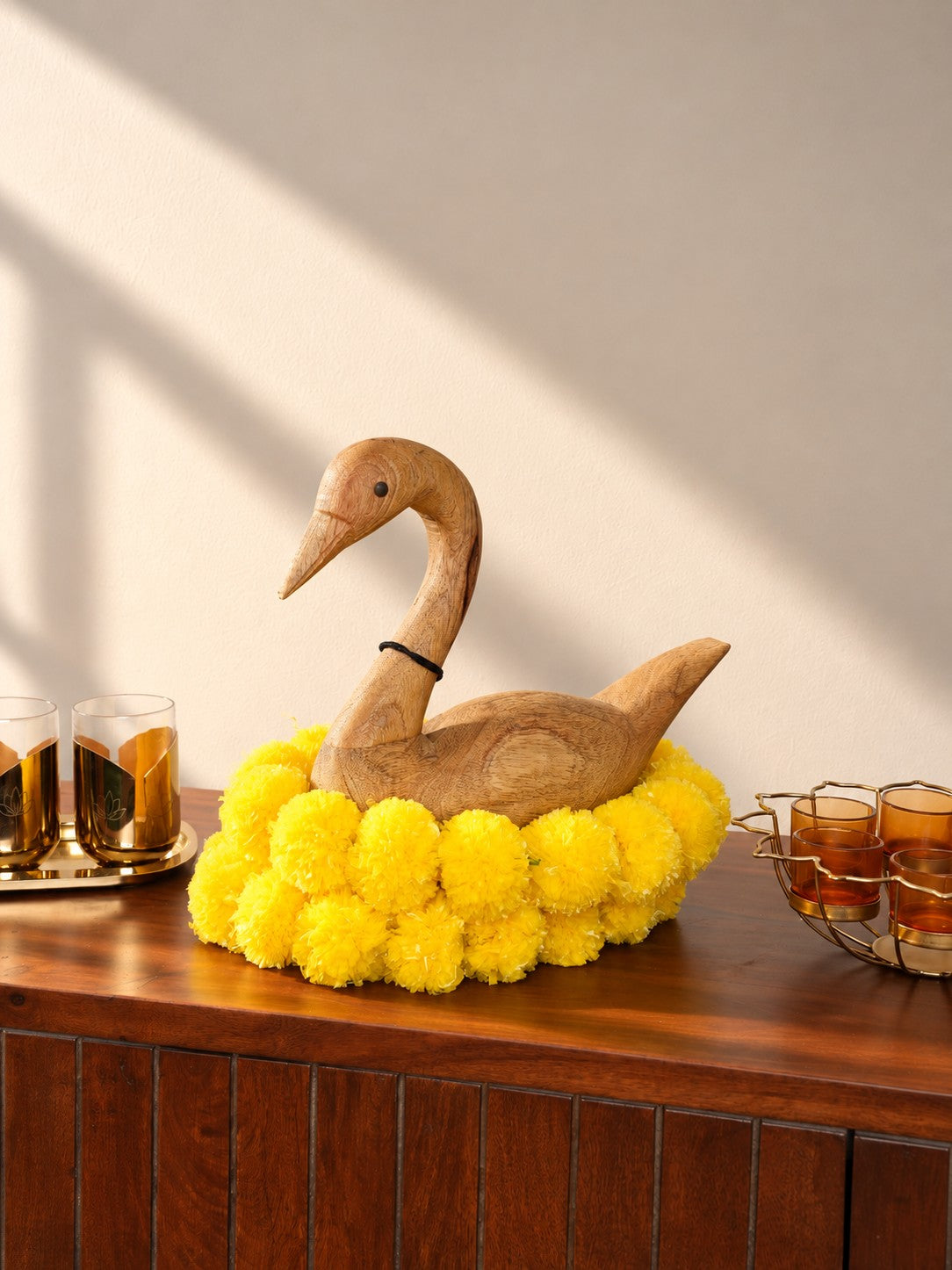 Mela Swan Sculpture styled with marigolds for Diwali