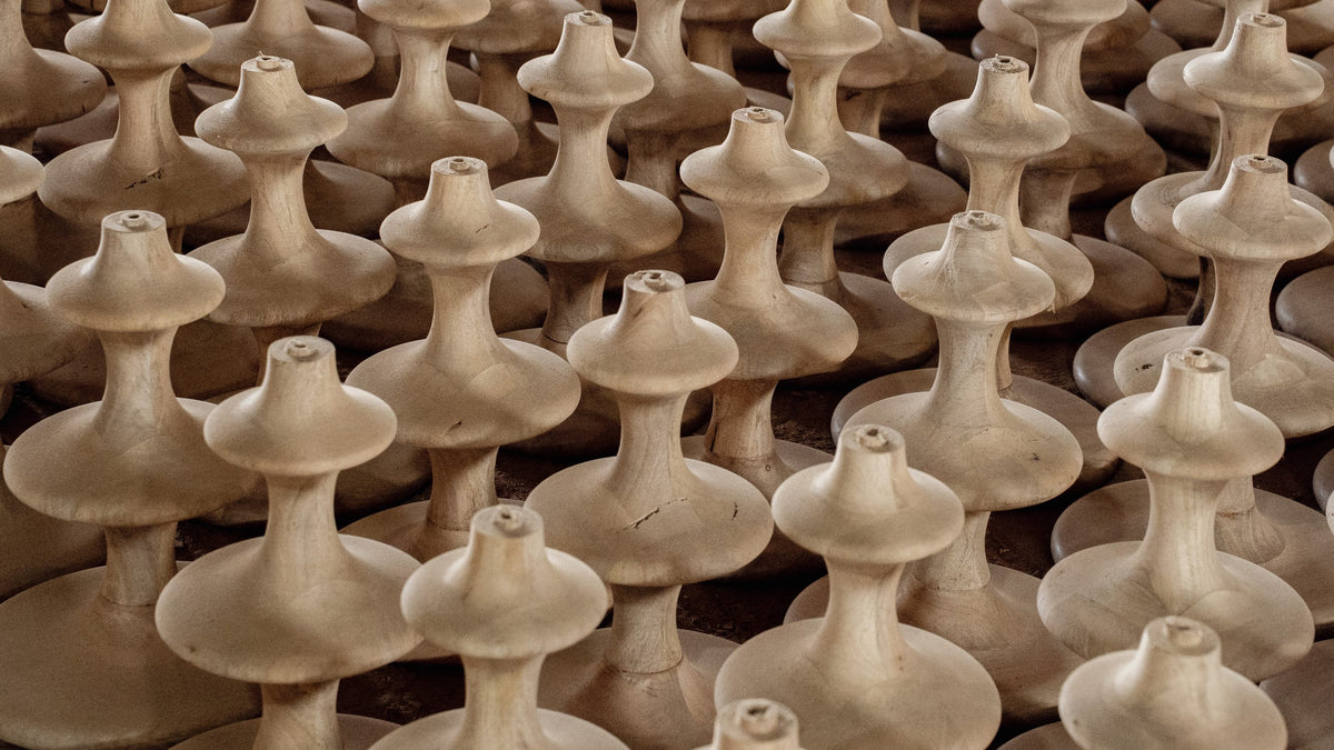Rows of hand-turned wooden lamp bases in the Mâzia workshop